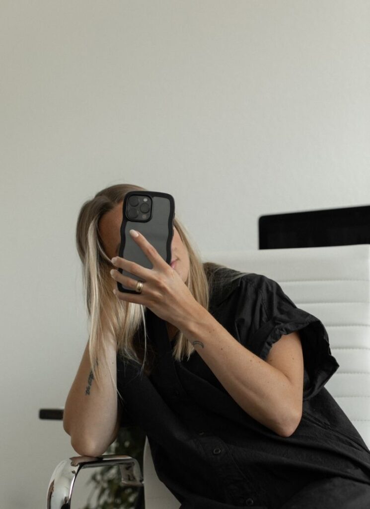 Blonde woman with smartphone in hand