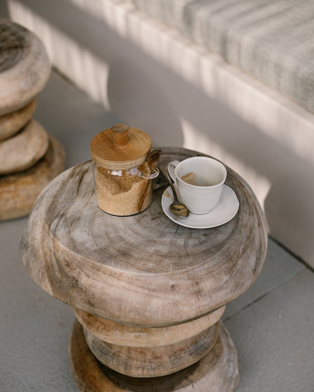 A rustic wooden stool serves as a quaint table for a traditional Greek coffee set, symbolizing the leisurely pace of life in Kefalonia.