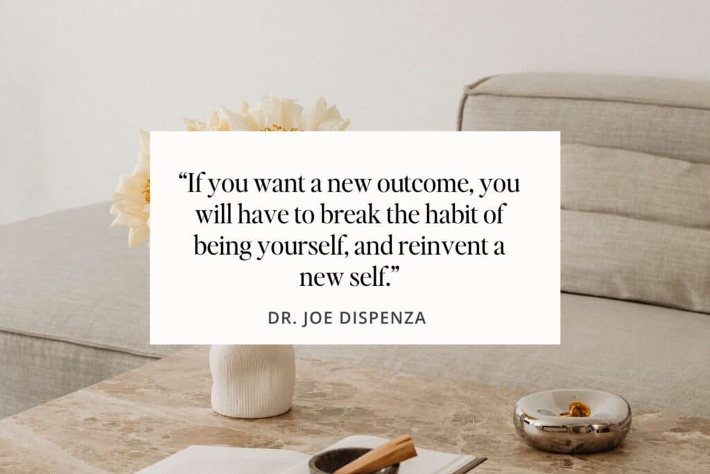 Image of a serene workspace with an inspirational quote card from Dr. Joe Dispenza reading 'If you want a new outcome, you will have to break the habit of being yourself, and reinvent a new self.