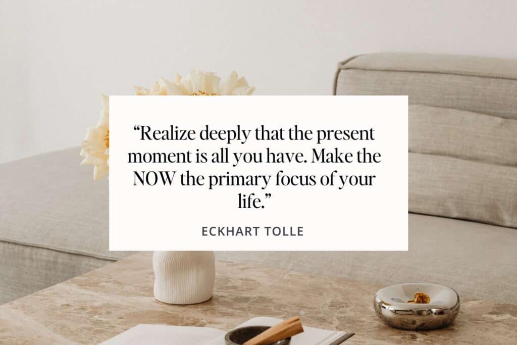 A tranquil workspace setting with a quote from Eckhart Tolle that reads 'Realize deeply that the present moment is all you have. Make the NOW the primary focus of your life.