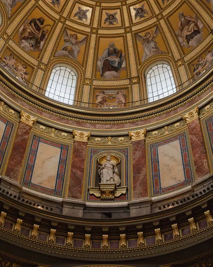 Richly adorned side dome and sculpture within St. Stephen's Basilica, surrounded by gold and marble