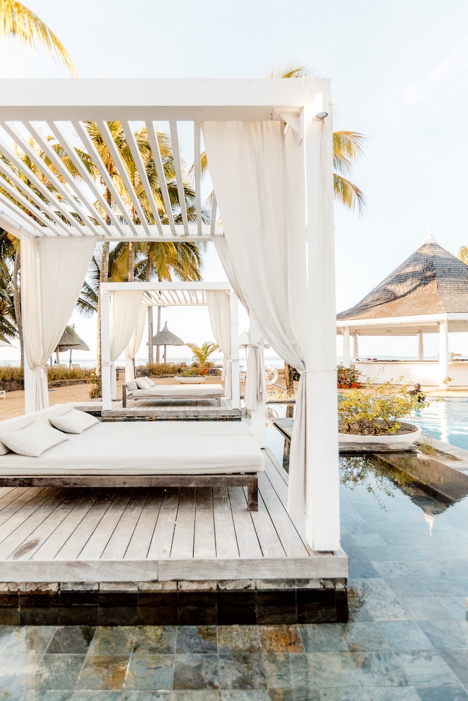 Outdoor pool lounge at Heritage Telfair Resort & Spa in Mauritius