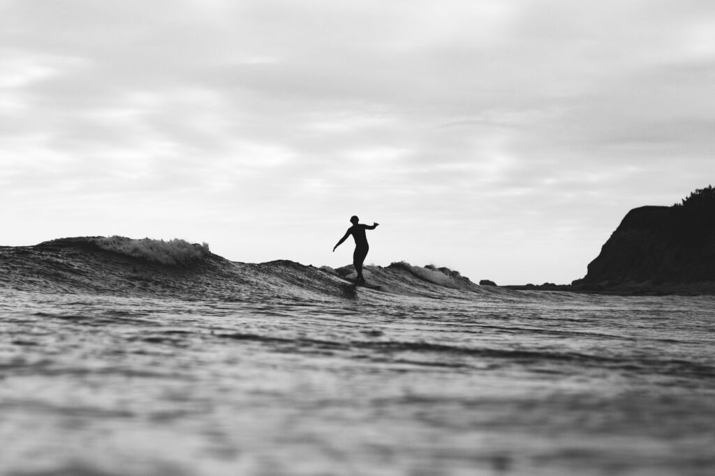 Black & White picture of a man surfing taken with a Telephoto lens