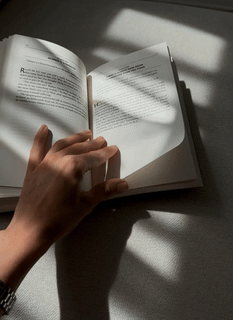 A gif of a person flipping through tghe pages of a book