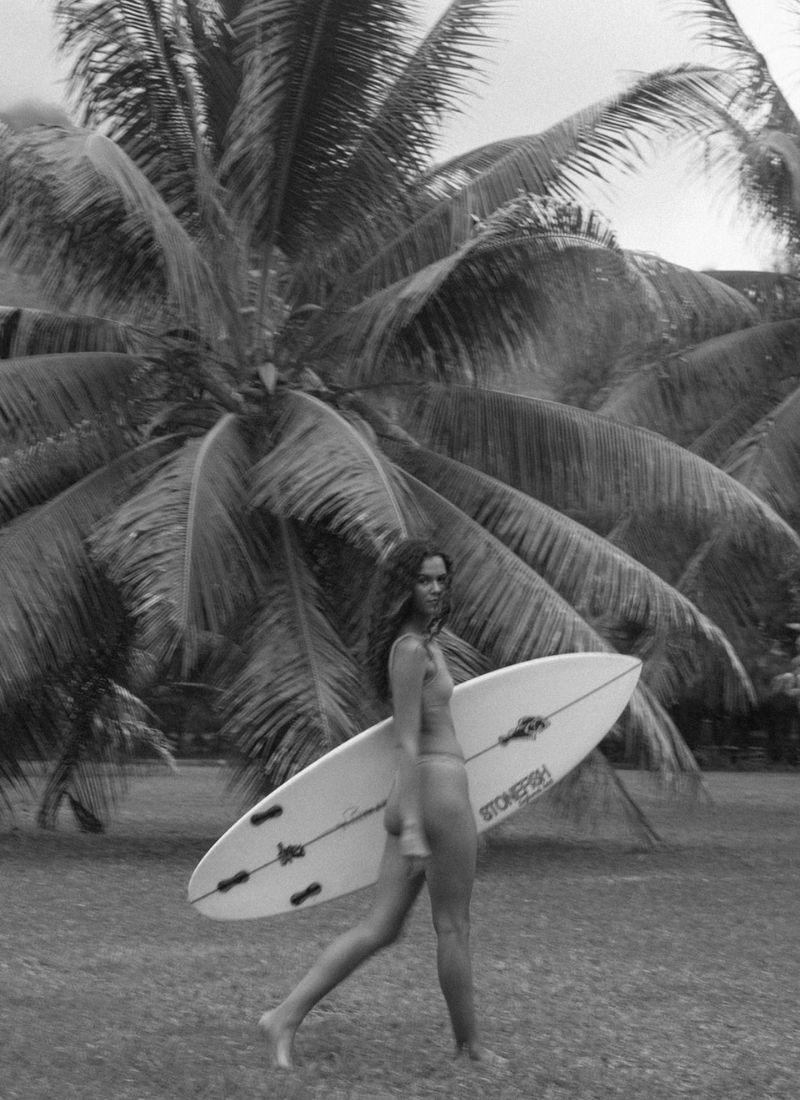 Woman in a bikini holding a surfboard
