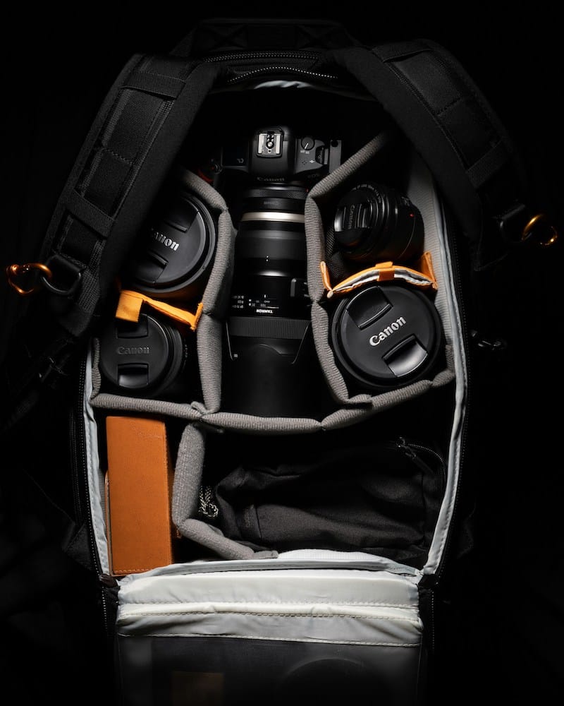 Professional photography equipment neatly packed in a compartmentalized camera bag, ready for travel.