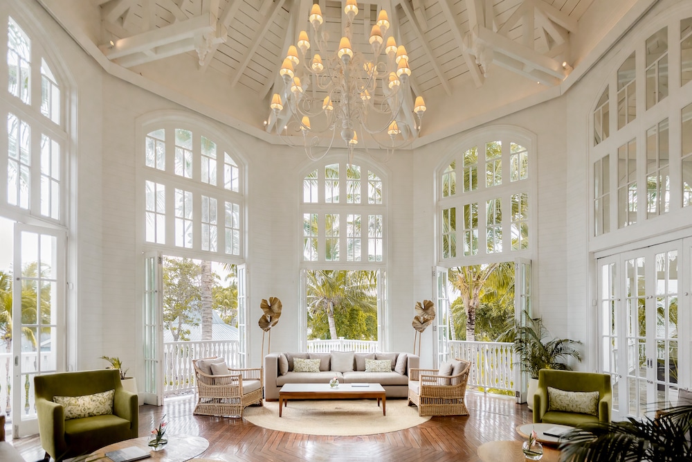 Elegant interior of the Telfair Heritage Wellness & Spa resort in Mauritius, with sunlight streaming through tall windows, embodying the luxury 