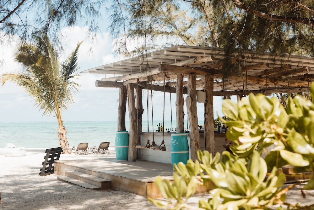 Is Mauritius worth visiting? This rustic beach bar set against the stunning backdrop of Ile aux Cerfs' azure waters, inviting relaxation and reinforcing why Mauritius is worth visiting.