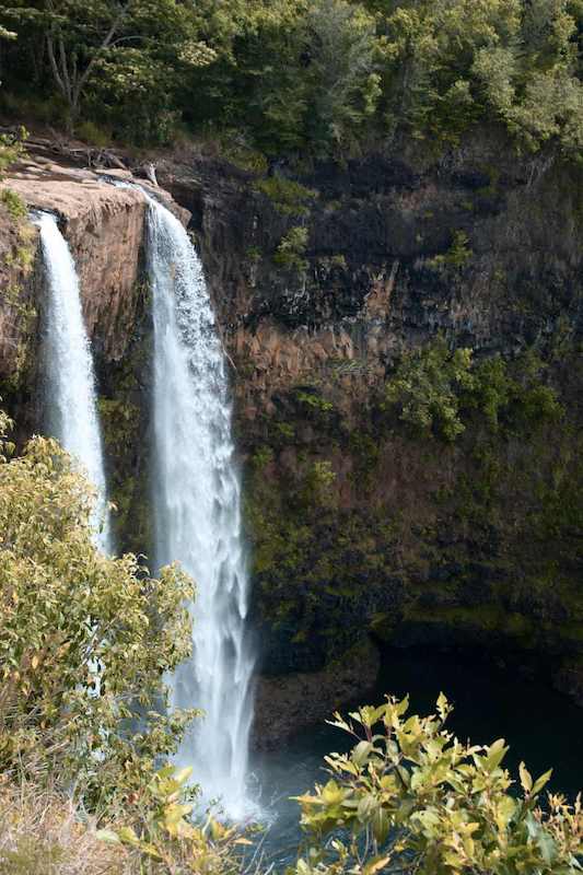 Is Mauritius worth visiting? The Chamarel Waterfall in Mauritius cascades powerfully into a lush basin, highlighting the island's stunning natural landscapes and inviting visitors to explore why.