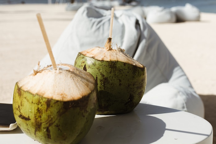 Fresh coconuts ready to be enjoyed at the Four Seasons at Anahita in Mauritius, highlighting the island's tropical offerings and answering 'Is Mauritius worth visiting?