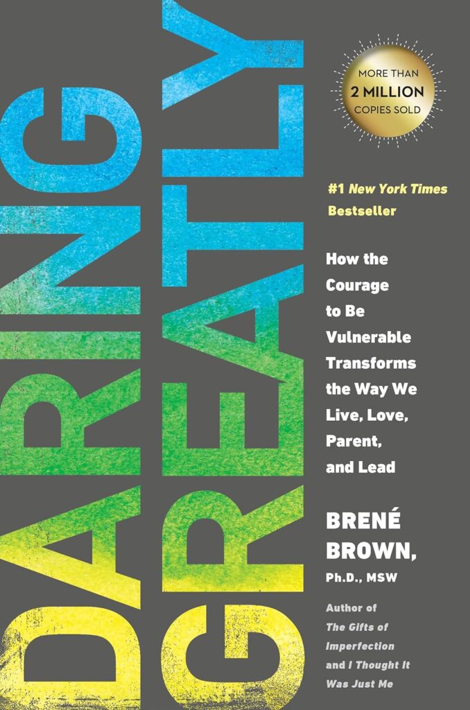 Cover of 'Daring Greatly' by Brené Brown, featuring large, bold letters against a textured grey background with a gold seal indicating over 2 million copies sold.