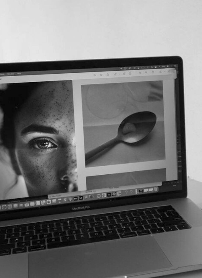 Minimalist workspace with an open laptop displaying fine art photography, symbolizing high-quality image editing and export.
