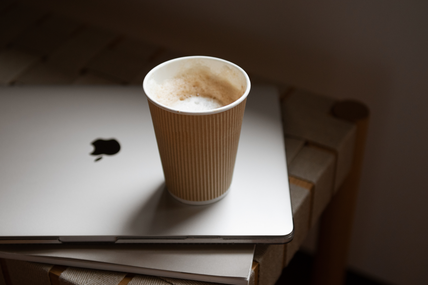 Apple MacBook with coffee mug on top